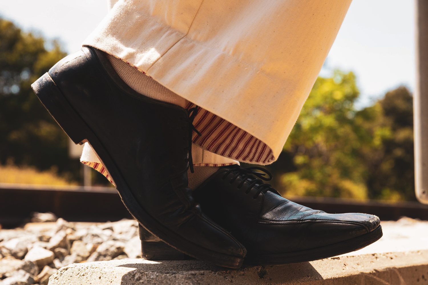 The hem turned up, revealing the red stripe at the cuff.